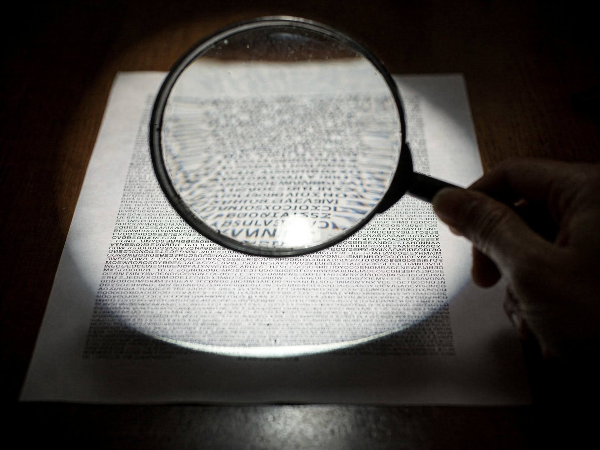 A magnifying glass over dense fine print on a payment-processing contract
